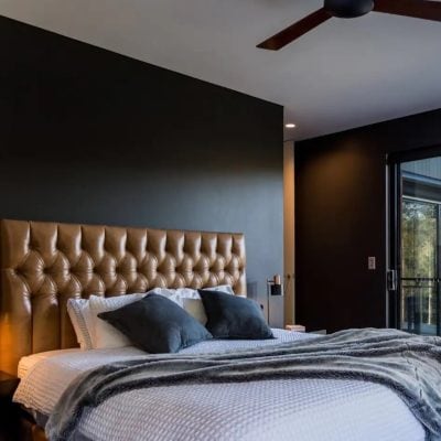Classic deep-buttoned bedhead in tan leather in a contemporary bedroom