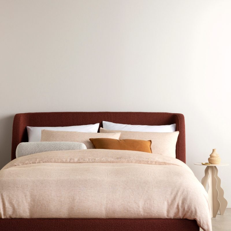 Textured boucle bedhead with wingback design and marble waved side table. With natural bedroom accessories