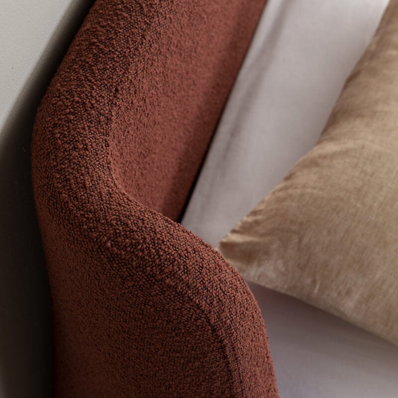 Curved boucle bed head wingback rust colour